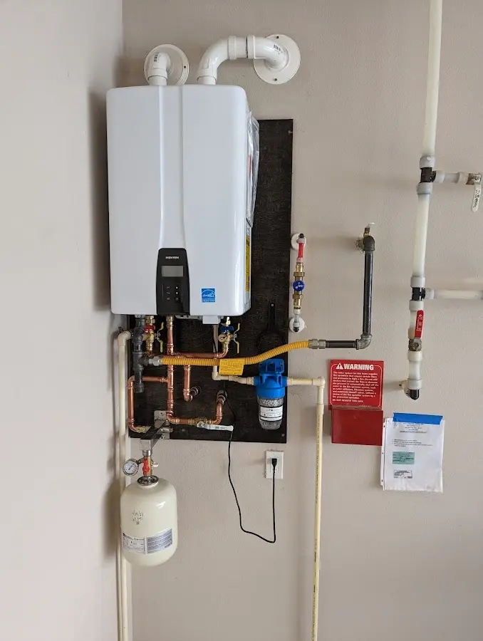 Professional plumber installing copper piping in a Andover home